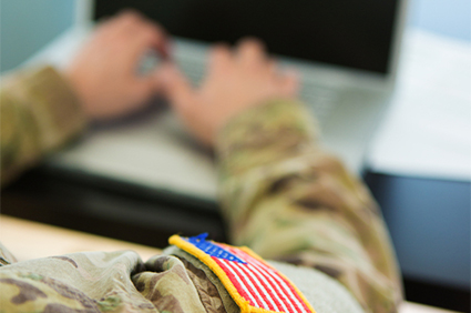 American Soldier typing on laptop