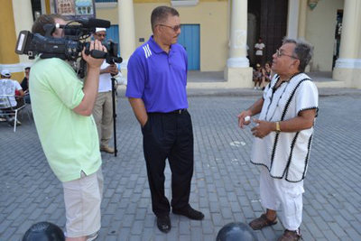 Ken DeVanney on camera, Prof. DeWayne Wickham and Cuban diplomat