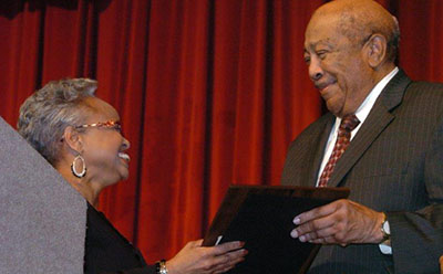 Sen. Gladys A. Robinson presents Dr. Quiester Craig with the Longleaf Pine Award from the governor of North Carolina.