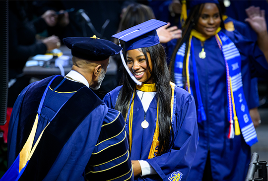 Graduating Students shaking Chancellor hand