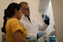 Instructor working with student in lab