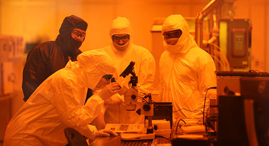 Four researchers collaborating in university lab